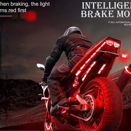 A motorcycle with glowing red LED light strips along the body and rear, shown from behind on a dark road. A rider in black riding gear is visible, and the scene includes promotional text reading 'INTELLIGENT BRAKE MODE' and 'When braking, the light turns red first.