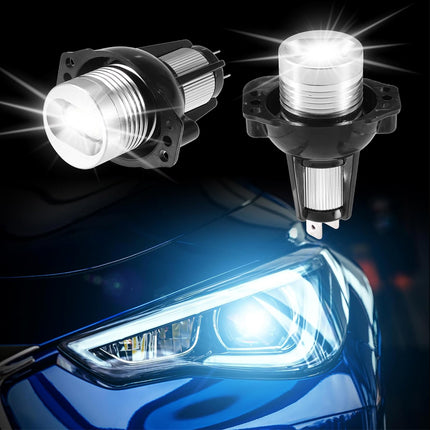 Two car headlights with a clear lens on a dark background