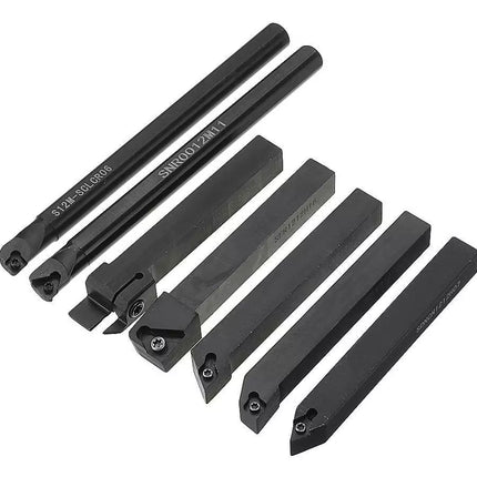 Set of black metal lathe tools on a white background