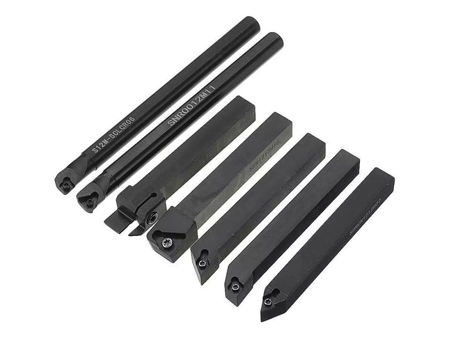 Set of black metal lathe tools on a white background