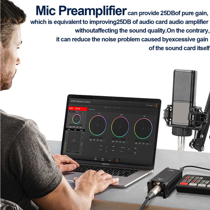 Person using a laptop with audio software, microphone, and preamplifier on a desk.