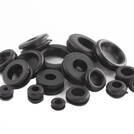 Collection of black rubber grommets on a white background