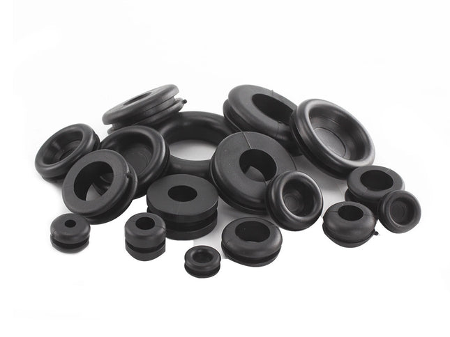 Collection of black rubber grommets on a white background