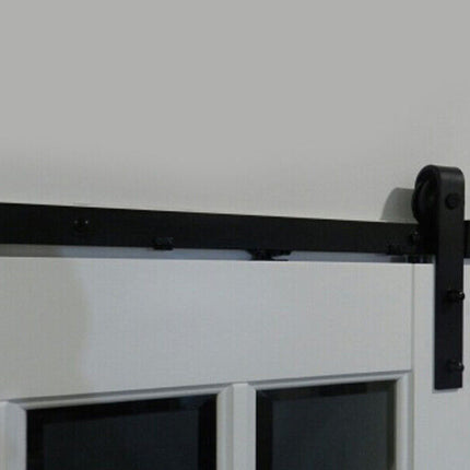 Black barn door hardware on a white sliding door