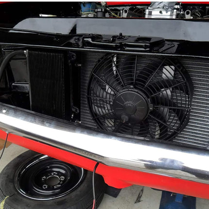 Car radiator with fan and oil pan on a red car chassis