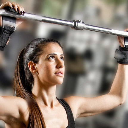 Woman exercising with a barbell in a gym setting