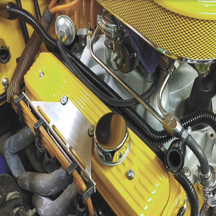 Close-up of a yellow engine with various components and hoses.