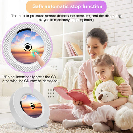 Woman and child reading a book with a teddy bear, featuring a CD player with safety features.