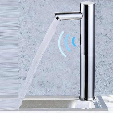 A modern chrome single-handle faucet with water flowing from the spout, shown against a textured light gray wall with a small lemon on a plate at the right edge.
