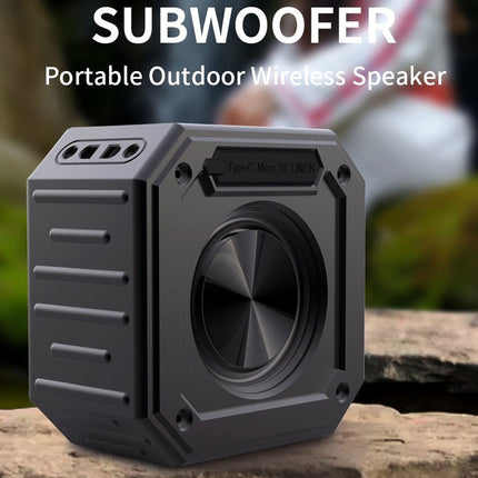 Portable outdoor wireless speaker labeled 'Subwoofer' on a natural background