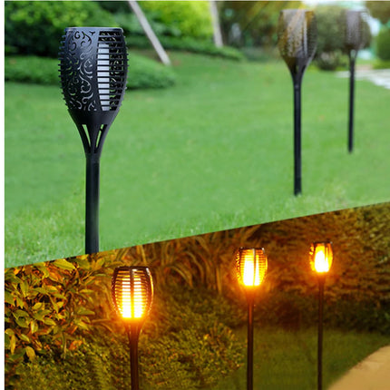 Solar garden lights with decorative patterns on a grassy background
