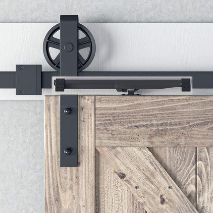 Barn door hardware system with wooden door on a light gray background