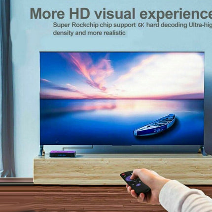 Smart TV displaying a scenic view with a person holding a remote control, set against a modern living room background.