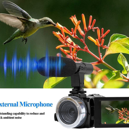 Camera with external microphone and hummingbird feeding on flowers
