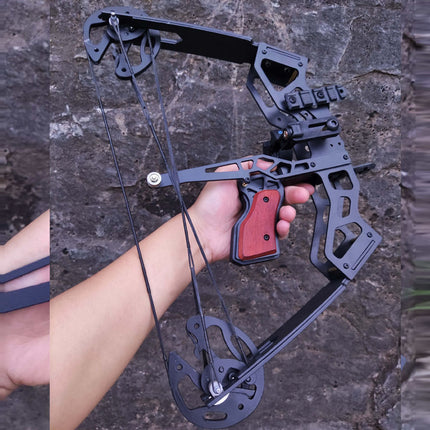 Hand holding a black crossbow against a stone wall background