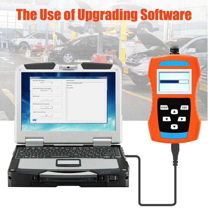 Laptop connected to a diagnostic tool with a car dealership background.