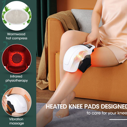 A woman sits on an orange sofa using a white heated knee massage pad with red light therapy. The left side features a dark green panel with three circular feature callouts: a wormwood hot compress, infrared physiotherapy, and vibration massage.