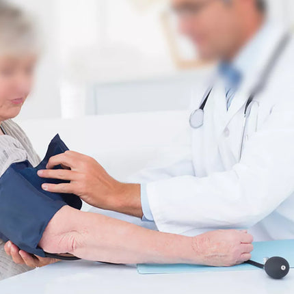 Doctor taking a patient's blood pressure with a focus on the action.
