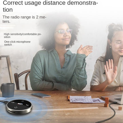 Two women sitting at a table with a device in front of them, demonstrating correct usage distance.