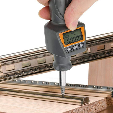 Digital screwdriver being used on a wooden surface