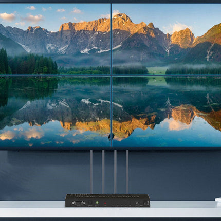 TV displaying a mountain landscape with a lake, with a projector below on a white surface.