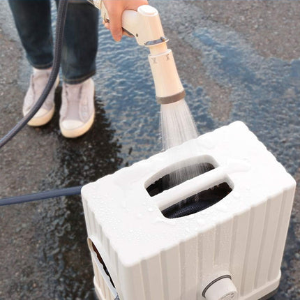 Person using a pressure washer to clean a surface