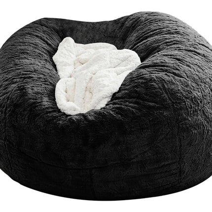 Black fuzzy bean bag chair with a white pillow inside on a white background