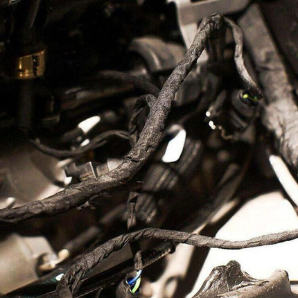 Close-up of a car's undercarriage with visible rust and mechanical components.