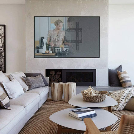 Living room with a TV displaying two people, a fireplace, and a sofa with pillows.
