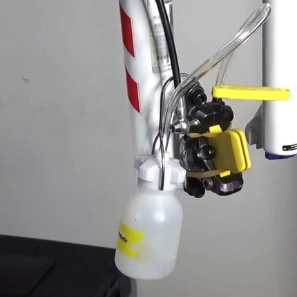 Close-up of a bicycle's front suspension fork with a white background