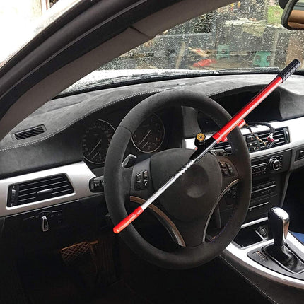 Steering wheel of a car with a red and black object on top