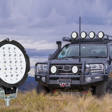 Off-road vehicle with large LED light on a mountainous landscape