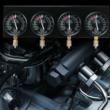 Four pressure gauges on a mechanical background