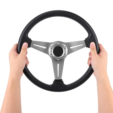 Steering wheel held by two hands on a white background