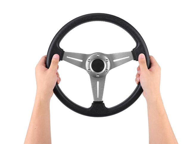 Steering wheel held by two hands on a white background