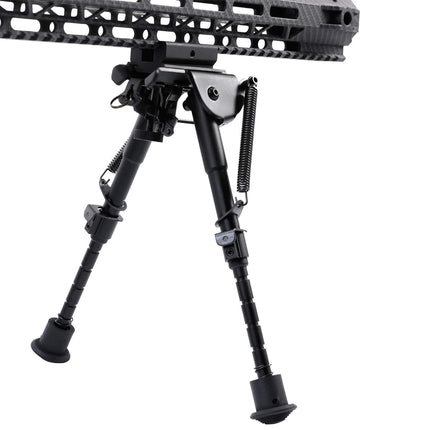 Black adjustable rifle bipod on a white background