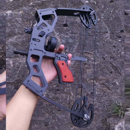 Hand holding a black archery bow against a stone background