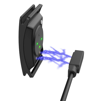 Black electronic device with green lights and a USB cable on a white background