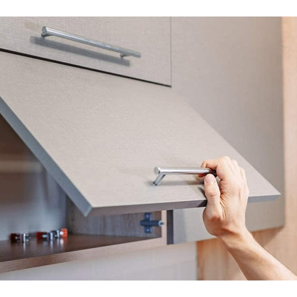 Hand opening a kitchen cabinet door with a focus on the hardware.