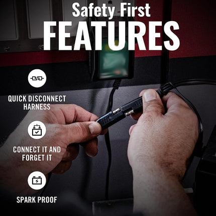 Person connecting a quick disconnect harness with safety features highlighted on a dark background.