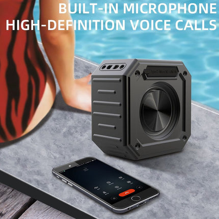 Portable speaker with smartphone on a surface near water