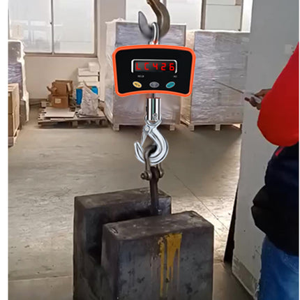 Digital hanging scale with a person using it in an industrial setting