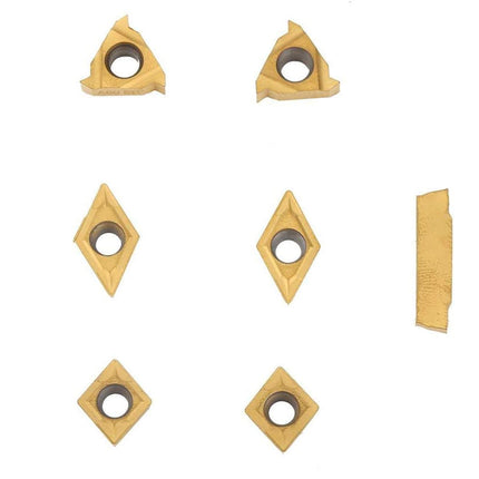 Set of various geometric metal cutting tools on a white background