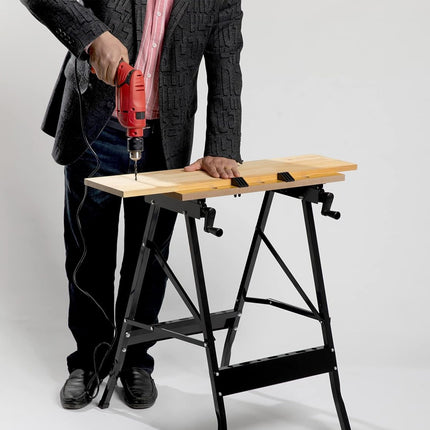 Person using a drill on a wooden board with a black metal stand against a white background