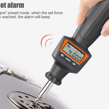Digital force gauge being used to measure force on a metal object with text explaining preset alarm function.