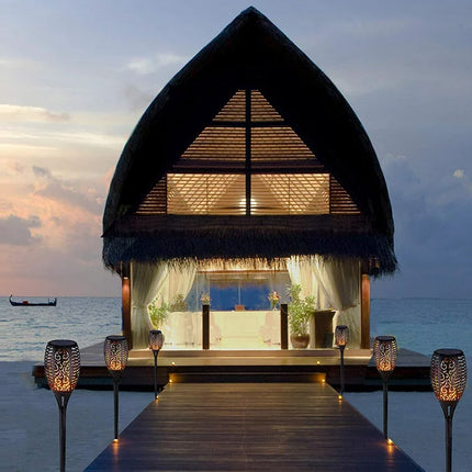 Gated house with a view of the ocean at sunset