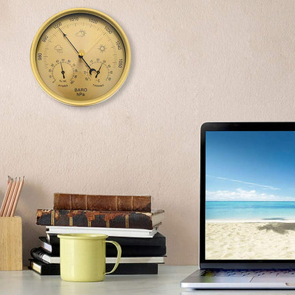 Laptop on a desk with a beach scene on the screen, next to a wall clock and stationery items.