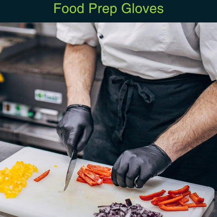 Person wearing black food prep gloves cutting vegetables on a white cutting board.