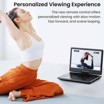 Woman practicing yoga in front of a laptop displaying a yoga video.