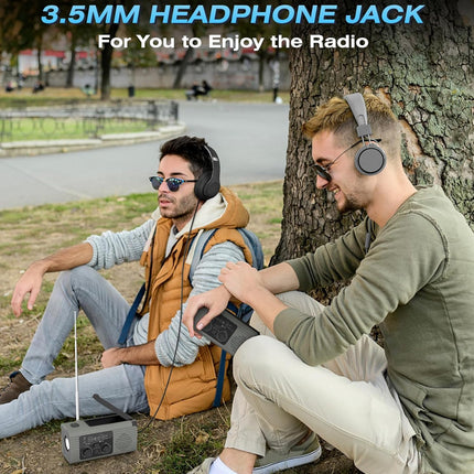 Two men sitting outdoors by a tree using over-ear headphones and a portable radio, with text at the top reading '3.5MM HEADPHONE JACK For You to Enjoy the Radio'.